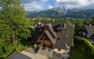 an aerial view of a house with mountains in the background at Panorama Szymaszkowa in Zakopane