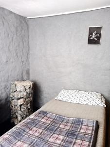 a bedroom with a bed and a stool in a room at Tierras Mágicas in Villa Pehuenia
