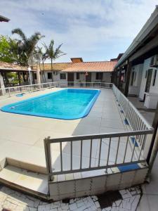 a swimming pool in the middle of a building with at Itapira Flats - Apto 7 in Imbituba +3 photos