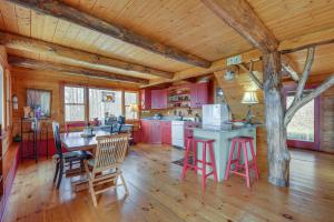 a kitchen with pink cabinets and a table and chairs at Remote Escape Vermont Cabin with Mountaintop Views! 
