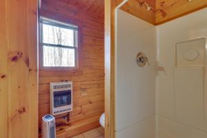 a bathroom with a toilet and a window at Remote Escape Vermont Cabin with Mountaintop Views! 