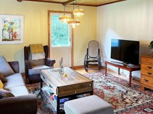 a living room with a couch and a tv at Holiday home Grängesberg in Grängesberg