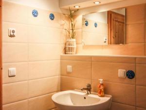 a bathroom with a sink and a mirror at Doppelhaushälfte Dünenrose, Glowe in Glowe +12 photos