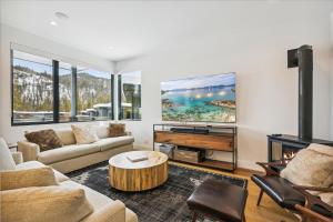 a living room with a couch and a table at NEW LISTING! Diamond Run at Palisades Tahoe - Pet Friendly and NEW hot tub! in Olympic Valley