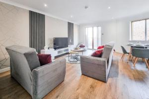 a living room with two couches and a television at Great Stunning Two Bedroom Apartment With Balcony in Manchester