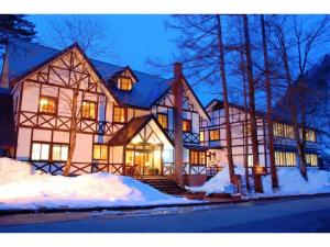 a large house with snow in front of it at Hotel Montblanc Hakuba - Vacation STAY 97827v in Hakuba