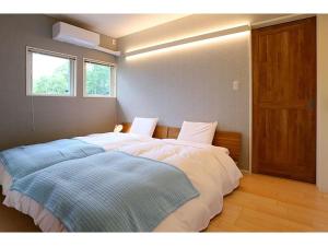 a bedroom with a large bed with two pillows at Class Vesso Tateshina - Vacation STAY 51972v in Chino