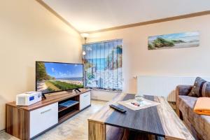 uma sala de estar com uma grande televisão de ecrã plano em Koserow, Koserower Strand - App em Ostseebad Koserow