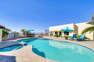 a swimming pool with two chairs and a building at Bright Cottage with Pool and Spa - 5 Mi to Lake Havasu in Lake Havasu City