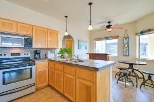 a kitchen with a sink and a stove top oven at Bright Cottage with Pool and Spa - 5 Mi to Lake Havasu in Lake Havasu City