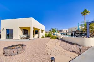 a house with a fire pit in front of it at Bright Cottage with Pool and Spa - 5 Mi to Lake Havasu in Lake Havasu City