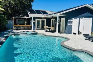 a swimming pool in front of a house at Large pool! Ping Pong! 3 Bedrooms and 2 Bath! in Clearwater Beach
