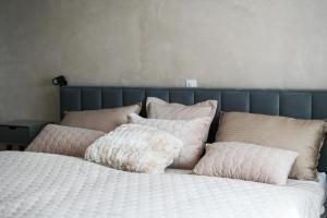 a bed with a bunch of pillows on it at Sunshinewilla com - amazing sea view - private pool - 4 bedrooms - 3 bathrooms - workout in Kaštelir +39 photos