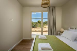 a bedroom with a large bed and a window at Santa Lucia - Villa&Boat in Turanj