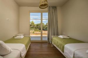 two beds in a room with a window at Santa Lucia - Villa&Boat in Turanj +37 photos