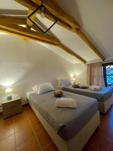 a bedroom with two beds in a attic at Windy Inns ( Maistros I ) in Vouyiáton