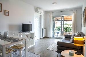 a living room with a couch and a table at New cosy apartments with private parking in Opatija