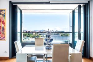 a dining room with a table and chairs and a large window at EuroSky Roma Eur in Rome