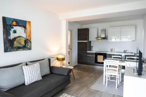 a living room with a couch and a kitchen at New cosy apartments with private parking in Opatija