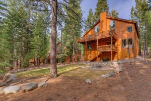 a large wooden house in the woods at High Country Lodge - Hot Tub, Amenities Access, Shuffleboard and Horse Shoe Pit in Truckee