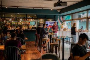 a group of people sitting at tables in a restaurant at Viajero Buenos Aires Hostel in Buenos Aires +41 photos