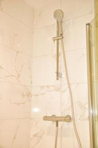 a shower with a shower head in a bathroom at AP- Luxury Apt nxt to o2 Academy in Birmingham