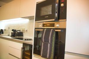 a kitchen with a microwave and a towel hanging under it at AP- Luxury Apt nxt to o2 Academy in Birmingham