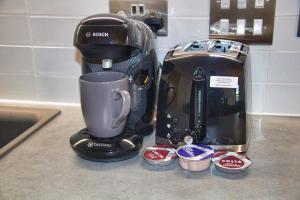 a coffee maker sitting on a counter next to a coffee pot at AP- Luxury Apt nxt to o2 Academy in Birmingham