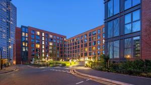 an empty street in a city with tall buildings at AP- Luxury Apt nxt to o2 Academy in Birmingham