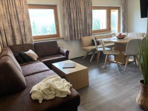 a living room with a couch and a table at Haus Anna in Sankt Anton am Arlberg