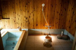 a bathroom with a tub with a toilet in it at Kusakimomotose - Vacation STAY 15480 in Yuzawa