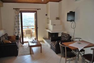 a living room with a couch and a table at Guesthouse Kallisti in Anilio Pelion