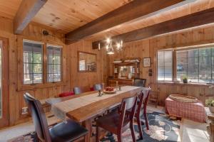 a dining room with a wooden table and chairs at Holly House on the West Shore - New Hot Tub, Wood Fireplace, Near Skiing in Tahoe City