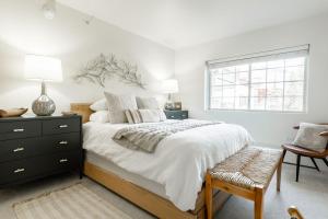a white bedroom with a bed and a window at 9 Vail Road Vail Village 1 to 4 Bedrooms by Vail Realty in Vail