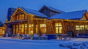 a large wooden building with benches in front of it at Kokanee at Tahoe Donner - Charming 3 BR - Pool Table - Fireplace - Amenity Access! in Truckee