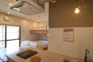 Habitación con cama y reloj en la pared en futaba heights - Vacation STAY 15415, en Tokio
