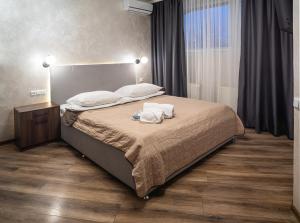 a bedroom with a bed with two towels on it at Safari-Club in Vinnytsya