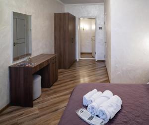 a hotel room with a bed with a sink and towels at Safari-Club in Vinnytsya