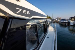 a boat is docked in a body of water at Santa Lucia - Villa&Boat in Turanj