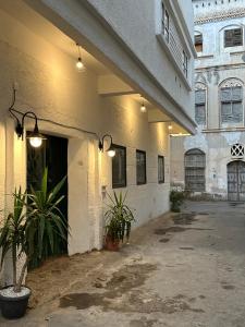 a building with potted plants in front of it at Dar Sayang in Taif