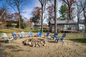 a group of chairs sitting around a fire pit at Waterfront Brainerd Cabin with Rice Lake Access! in Brainerd