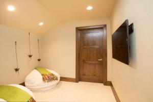 a room with a door and a pillow and a television at Mountainside - Luxury Northstar Ski-in Ski-Out - Swimming Pool and Gym! in Truckee