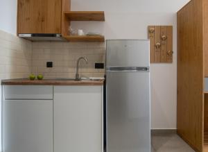 a kitchen with a refrigerator and a sink at Vrahakia beach in Sarti