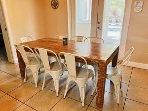 a dining room table with white chairs around it at 5 Bedrooms with pool near beach in Clearwater Beach
