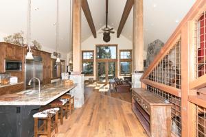 a large kitchen with wooden floors and wooden beams at Overlook Lake View Lodge at Tahoe Donner- Dog Friendly 4BR with Private Hot Tub in Truckee