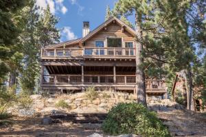 a log home with a wrap around porch at Overlook Lake View Lodge at Tahoe Donner- Dog Friendly 4BR with Private Hot Tub in Truckee