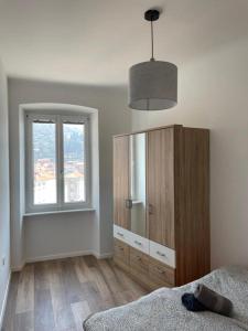 a bedroom with a large wooden cabinet and a window at Casa Maria in Piran