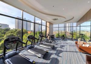 a gym with a row of treadmills in a building at The Panora Pattaya in Pattaya South