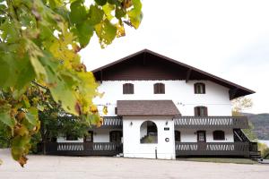 a large white building with a black roof at Amazing Lakemountain View 5min To Tremblant431 in Mont-Tremblant