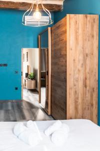 a bedroom with blue walls and a large wooden door at Valletta Stylish 2 Beds Flat in Valletta